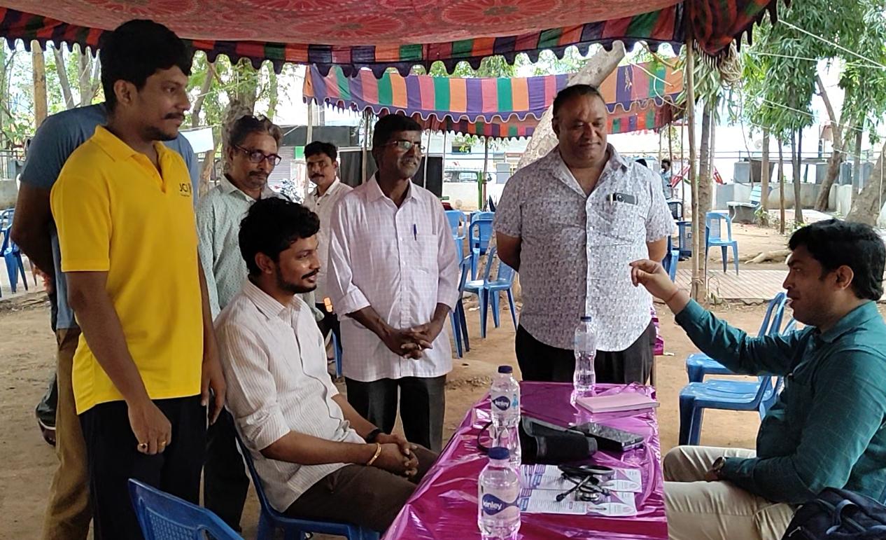Naveen Kumar interacting with residents at an outdoor camp