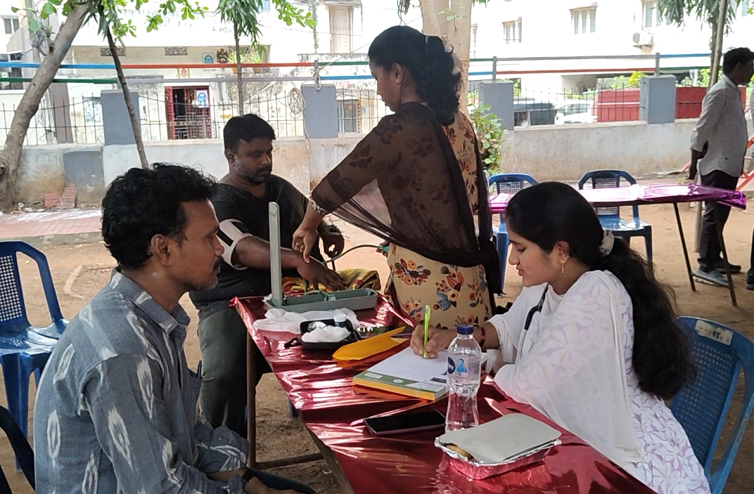 Naveen Kumar with residents at a community health camp