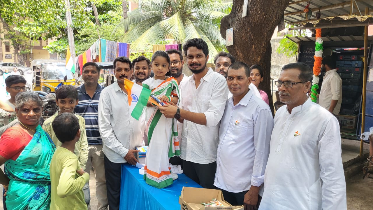 Naveen Kumar with residents and children at a community celebration